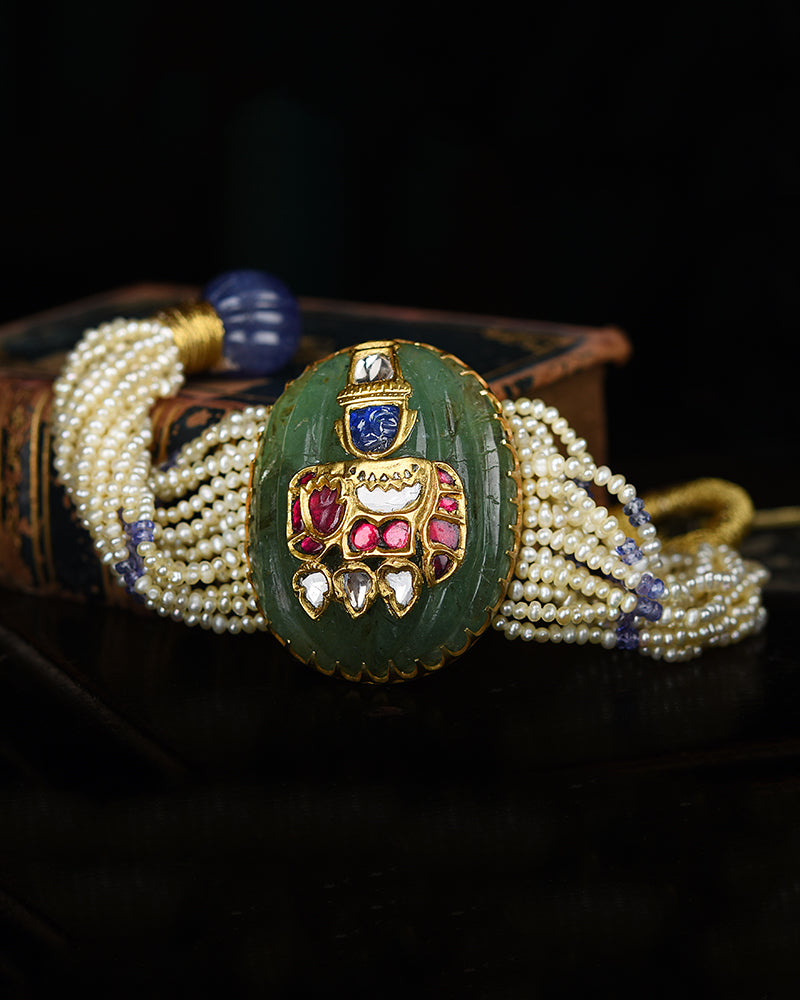 24KT GOLD SRINATHJI BRACLET ON CARVED EMERALD